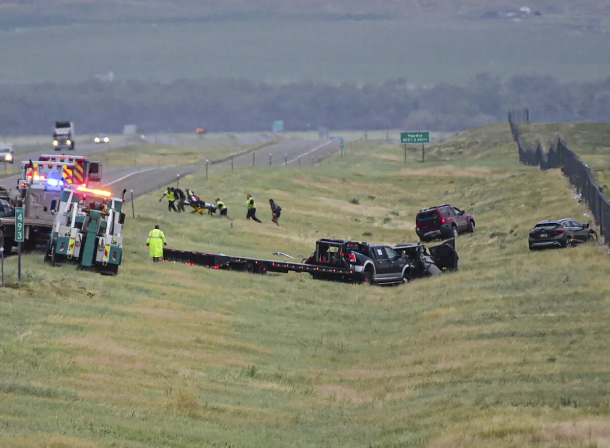 First responders work the scene on Interstate 90 after a fatal pileup where at least 20 vehicles crashed near Hardin, Mont., on July 15, 2022. (Amy Lynn Nelson/The Billings Gazette via AP)