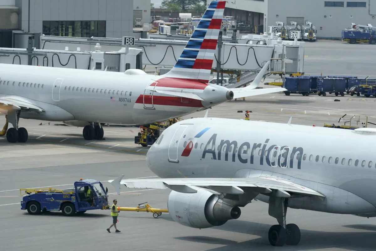 American Airlines passenger jets prepare for departure, near a terminal at Boston Logan International Airport in Boston, Mass., on July 21, 2021. (Steven Senne/AP Photo)