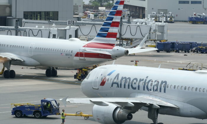 American Airlines passenger jets prepare for departure, near a terminal at Boston Logan International Airport in Boston on July 21, 2021. (Steven Senne/AP Photo)