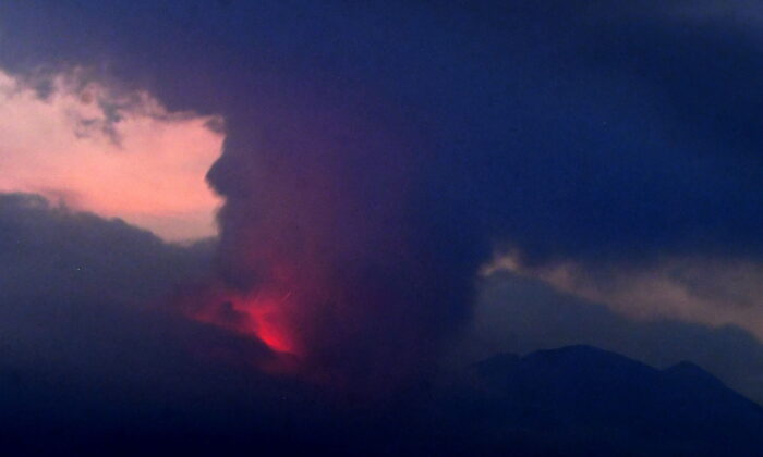 Volcano Sakurajima, seen from Tarumizu city, Japan's southern prefecture of Kagoshima, erupts on July 24, 2022. (Kyodo News via AP)