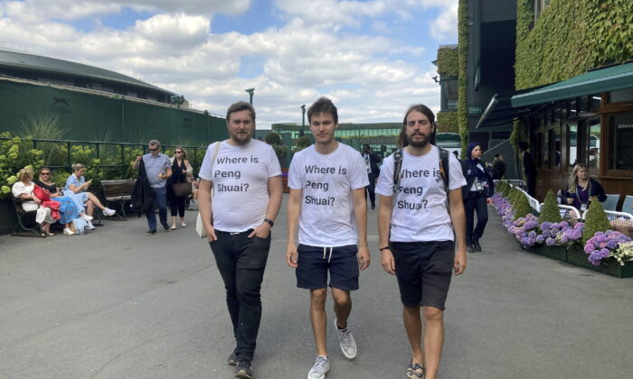 Protesters Will Hoyles, 39 (L), Caleb Compton, 27 (C), and Jason Leith, 34, who all work for Free Tibet, pose for the media in T-shirts reading "Where is Peng Shuai" at the Wimbledon Tennis tournament in London on July 4, 2022. (Rebecca Speare-Cole/PA via AP)
