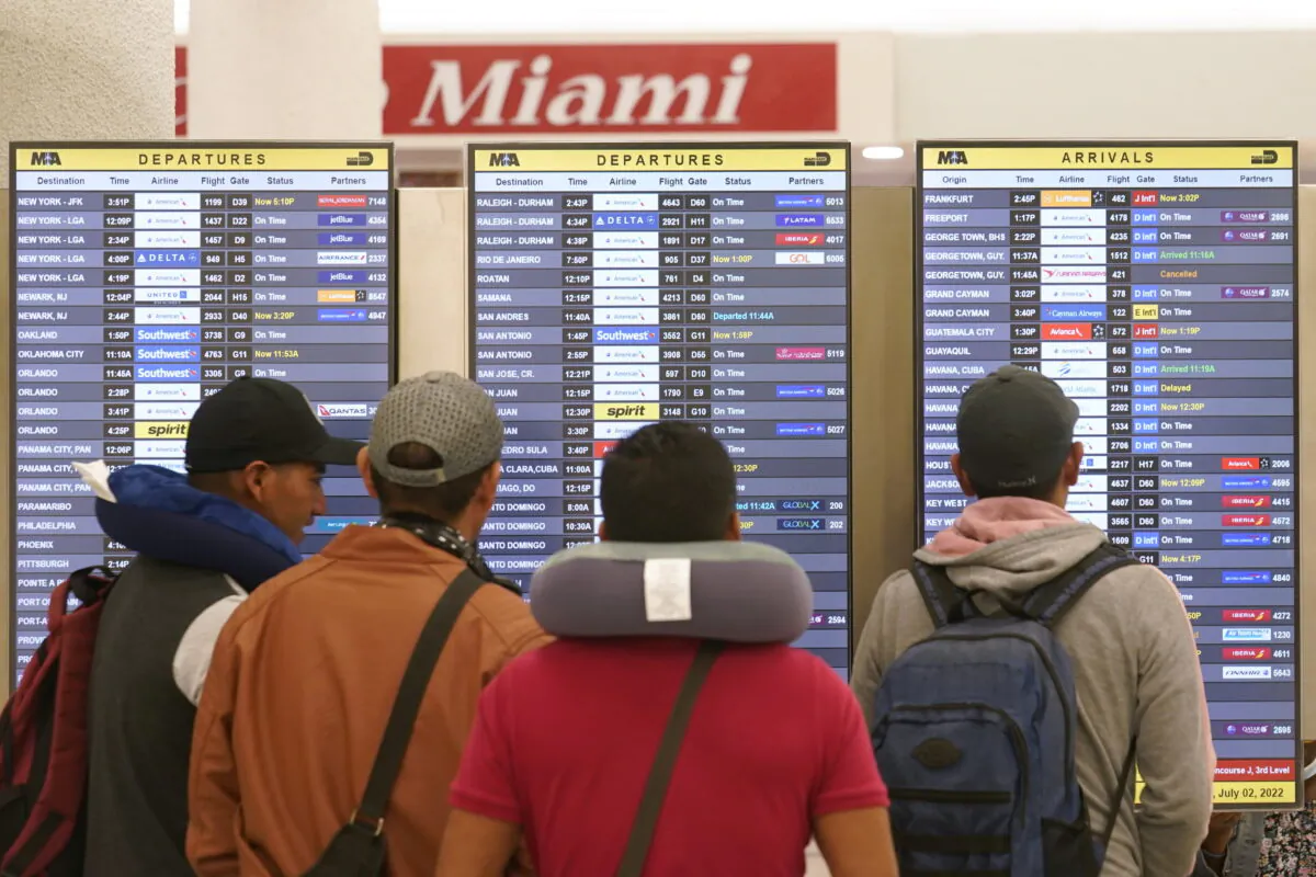 Travelers check their flights at Miami International Airport in Miami on July 2, 2022. (Marta Lavandier/AP Photo)