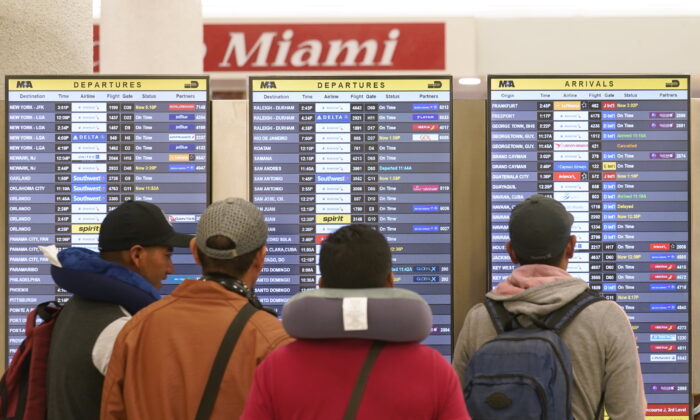 Travelers check their flights at Miami International Airport in Miami on July 2, 2022. (Marta Lavandier/AP Photo)