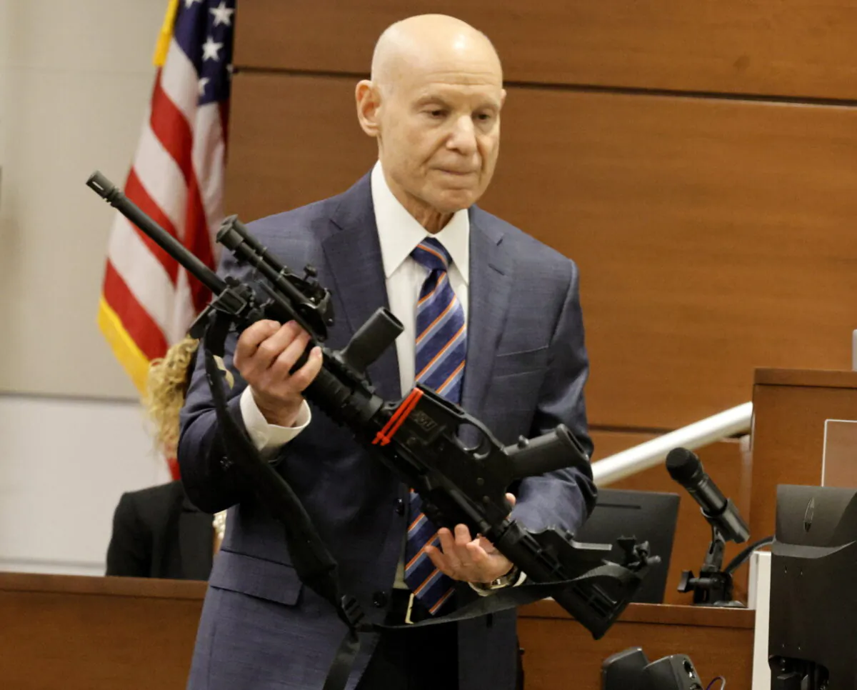 Assistant State Attorney Mike Satz checks into evidence the weapon used in the MSD shooting during the penalty phase of shooter Nikolas Cruz at the Broward County Courthouse in Fort Lauderdale, Fla., on July 25, 2022. (Carline Jean/ Florida Sun Sentinel via AP, Pool)