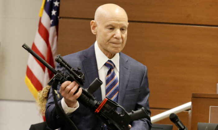 Assistant State Attorney Mike Satz checks into evidence the weapon used in the MSD shooting during the penalty phase of shooter Nikolas Cruz at the Broward County Courthouse in Fort Lauderdale, Fla., on July 25, 2022. (Carline Jean/ Florida Sun Sentinel via AP, Pool)