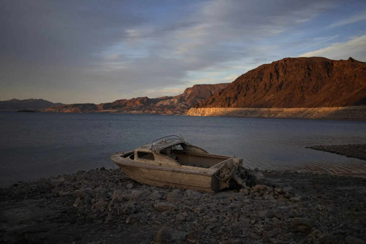 A formerly sunken boat sits high and dry along the shoreline of Lake Mead at the Lake Mead National Recreation Area, near Boulder City, Nev., on May 10, 2022. (John Locher/AP Photo)