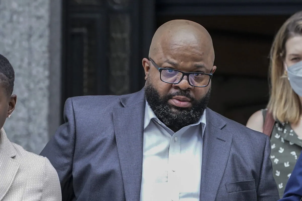R. Kelly's manager Donnell Russell (2nd L) leaves federal court in New York on July 20, 2022. (Mary Altaffer/AP Photo)