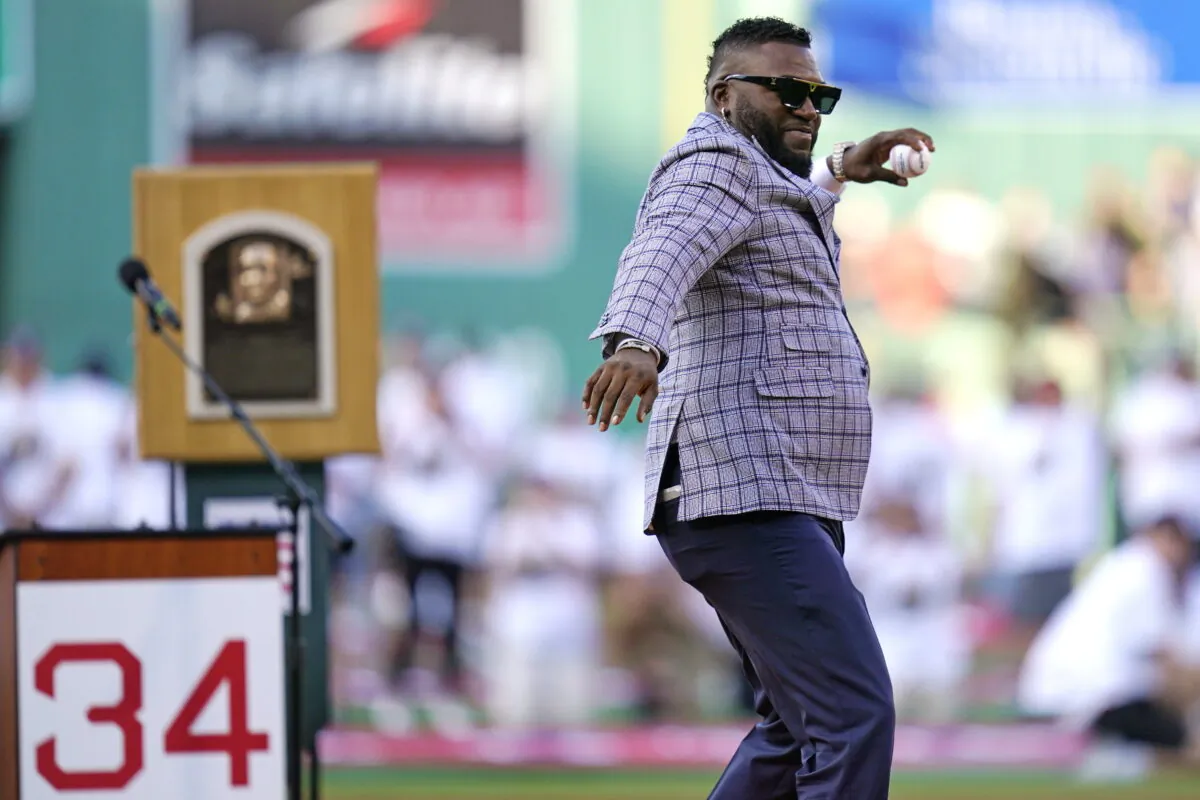 Newly inducted Hall of Fame designated hitter David Ortiz throws out the ceremonial first pitch while being honored prior to a baseball game between the Boston Red Sox and Cleveland Guardians at Fenway Park in Boston on July 26, 2022. (Charles Krupa/AP Photo)