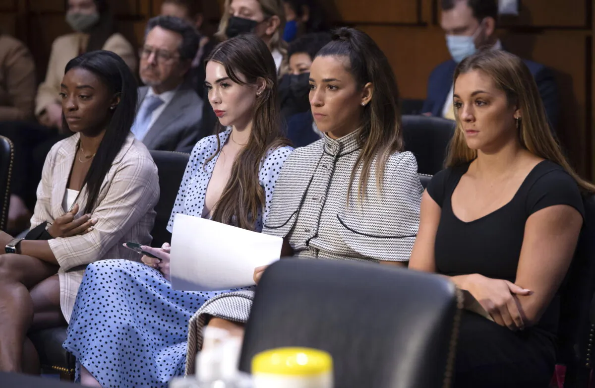 United States gymnasts Simone Biles (L), McKayla Maroney (2L), Aly Raisman (2R) and Maggie Nichols (R), wait to testify during a Senate Judiciary on the FBI's handling of the Larry Nassar investigation on Capitol Hill, in Washington, on Sept. 15, 2021. (Saul Loeb/Pool via AP, File)