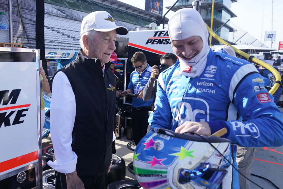 Roger Penske talks with Josef Newgarden (R) before a practice session for the IndyCar auto race at Indianapolis Motor Speedway in Indianapolis on July 29, 2022. (Darron Cummings/AP Photo)