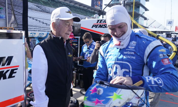 Roger Penske talks with Josef Newgarden (R) before a practice session for the IndyCar auto race at Indianapolis Motor Speedway in Indianapolis on July 29, 2022. (Darron Cummings/AP Photo)