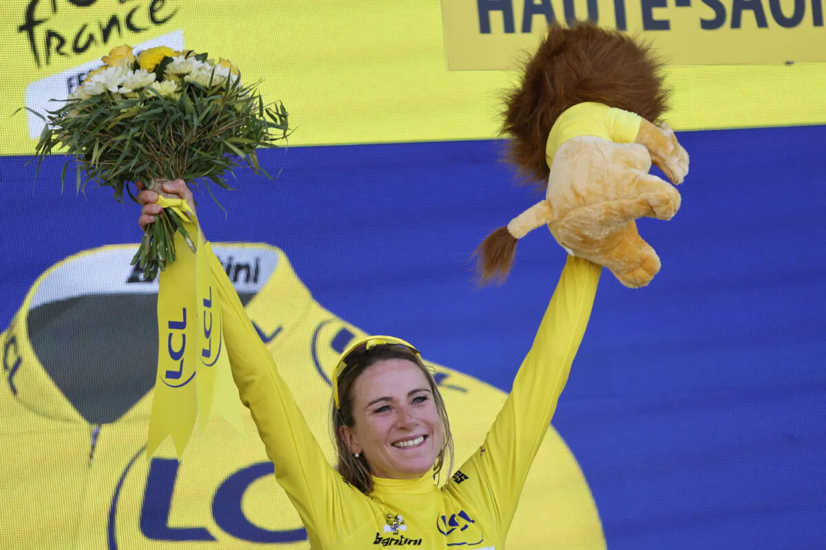 Netherland's Annemiek Van Vleuten, wearing the overall leader's yellow jersey, celebrates on the podium after winning the Tour de France women's cycling race in La Super Planche des Belles Filles, eastern France, on July 31, 2022. (Jean-Francois Badias/AP Photo)
