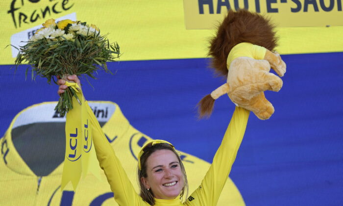 Netherland's Annemiek Van Vleuten, wearing the overall leader's yellow jersey, celebrates on the podium after winning the Tour de France women's cycling race in La Super Planche des Belles Filles, eastern France, on July 31, 2022. (Jean-Francois Badias/AP Photo)