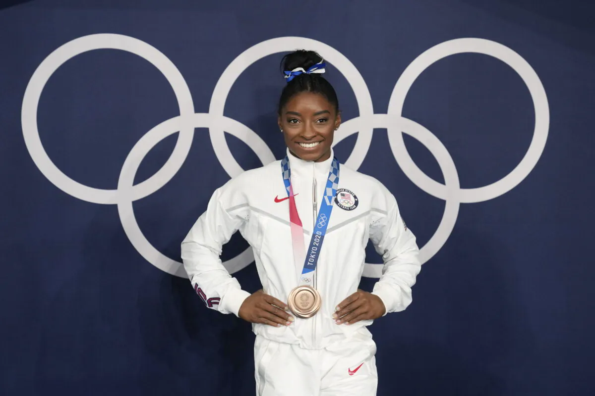 Simone Biles of the United States poses wearing her bronze medal from balance beam competition during artistic gymnastics at the 2020 Summer Olympics in Tokyo on Aug. 3, 2021. (Natacha Pisarenko/AP Photo)
