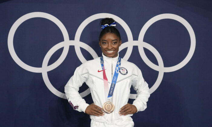 Simone Biles of the United States poses wearing her bronze medal from balance beam competition during artistic gymnastics at the 2020 Summer Olympics in Tokyo on Aug. 3, 2021. (Natacha Pisarenko/AP Photo)