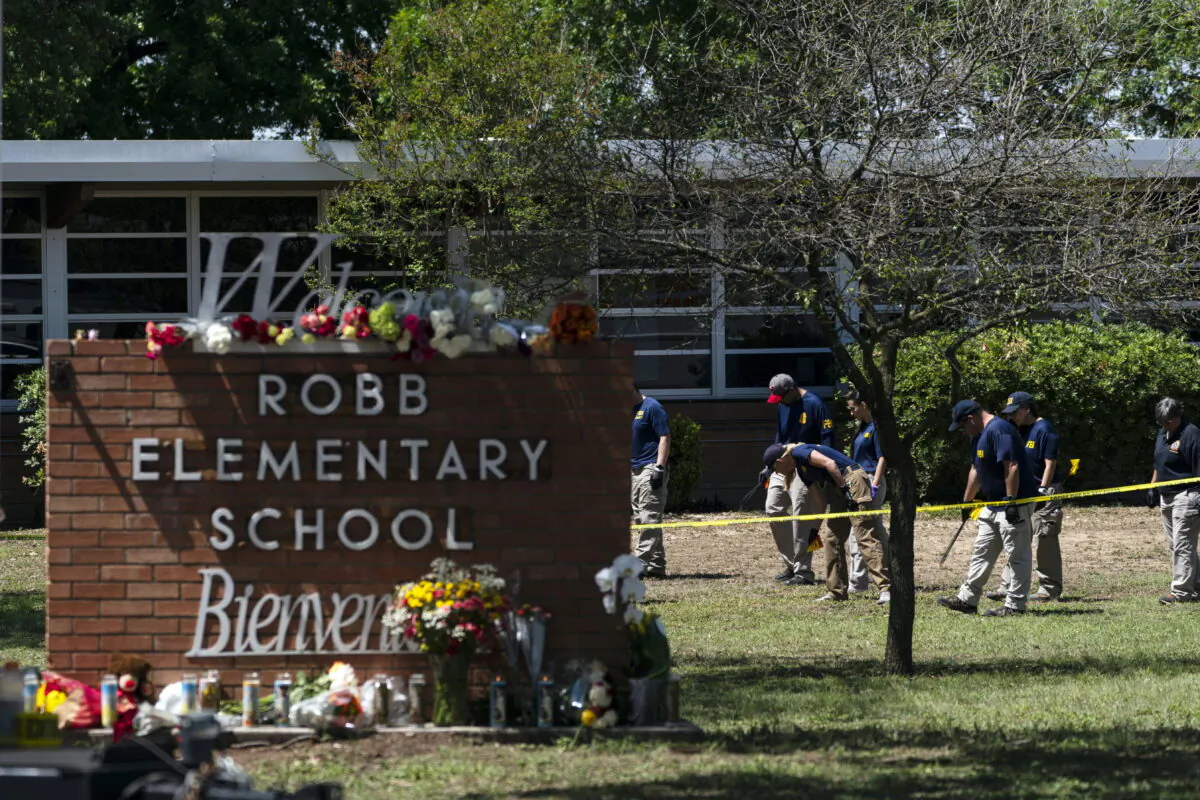 Investigators search for evidences outside Robb Elementary School in Uvalde, Texas, on May 25, 2022, after an 18-year-old gunman killed 19 students and two teachers. (Jae C. Hong/AP Photo)