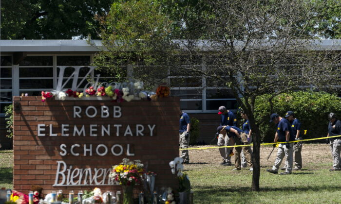 Investigators search for evidences outside Robb Elementary School in Uvalde, Texas, on May 25, 2022, after an 18-year-old gunman killed 19 students and two teachers. (Jae C. Hong/AP Photo)