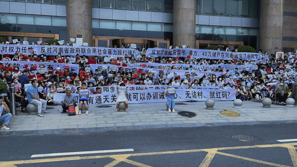 Chinese people hold banners