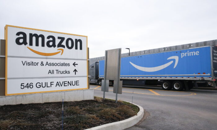 An Amazon Prime truck passes by a sign outside an Amazon fulfillment center in the Staten Island borough of New York City on March 19, 2020. (Kathy Willens/AP Photo)