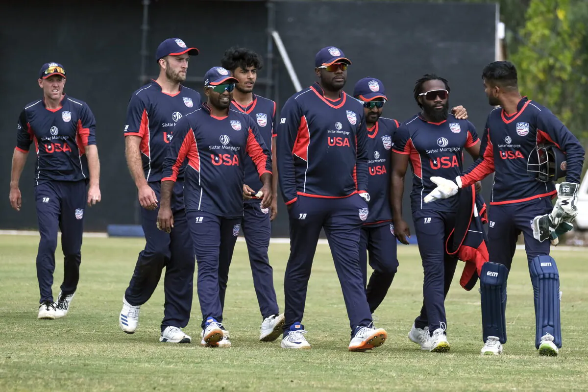 U.S. cricket players walk off the pitch after beating Singapore by 132 runs in a cricket World Cup qualifier match in Bulawayo, Zimbabwe, on July, 12, 2022. (KB Mpofu/AP Photo)