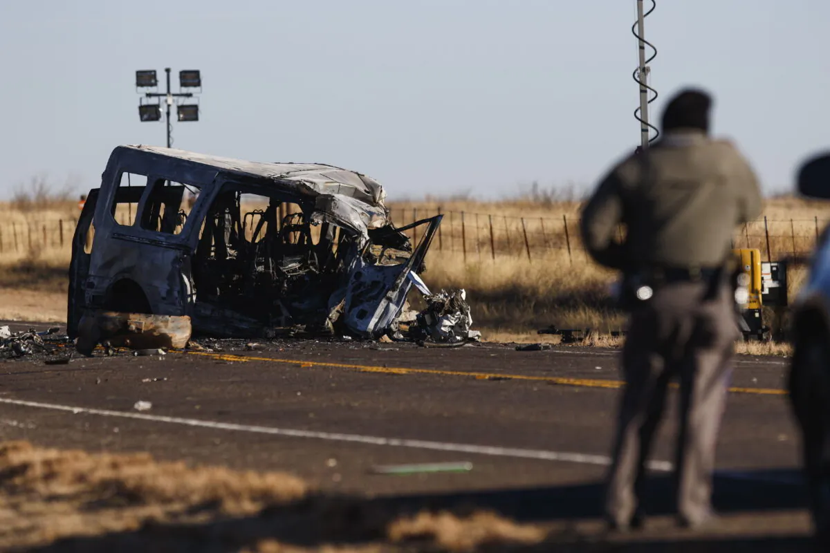 Texas Department of Public Safety Troopers look over the scene of a fatal car wreck, half of a mile north of State Highway 115 on Farm-to-Market Road 1788 in Andrews County, Texas, early on March 16, 2022. (Eli Hartman/Odessa American via AP)