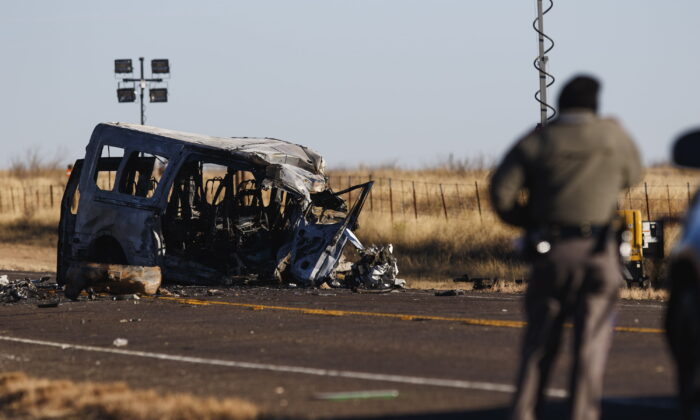 Texas Department of Public Safety Troopers look over the scene of a fatal car wreck, half of a mile north of State Highway 115 on Farm-to-Market Road 1788 in Andrews County, Texas, early on March 16, 2022. (Eli Hartman/Odessa American via AP)