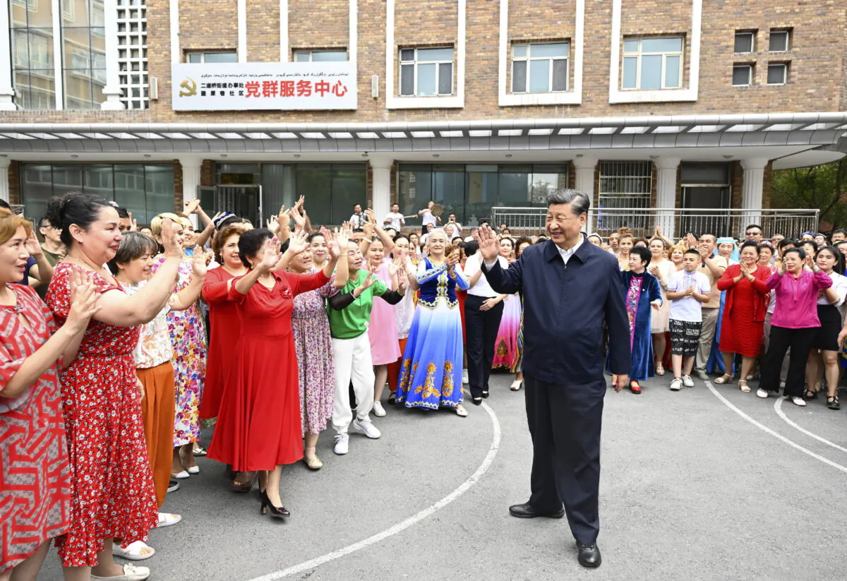 Chinese regime leader Xi Jinping (C) visits the community of Guyuanxiang in the Tianshan District in Urumqi in China's Xinjiang Uyghur Autonomous Region, July 13, 2022. (Li Xueren/Xinhua via AP)