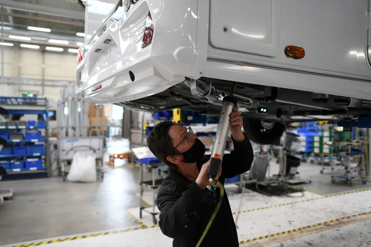 A worker assembles a vehicle at the Knaus-Tabbert AG factory in Jandelsbrunn near Passau, Germany, on March 16, 2021. (Andreas Gebert/Reuters)