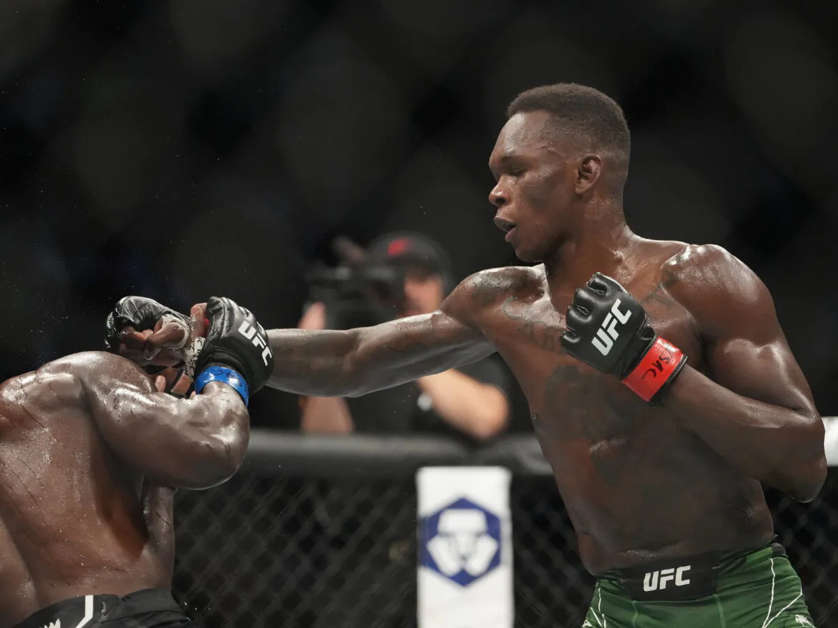 Israel Adesanya (red gloves) and Jared Cannonier (blue gloves) fight in a bout during UFC 276 at T-Mobile Arena in Las Vegas on July 2, 2022. (Stephen R. Sylvanie/USA TODAY Sports via Reuters)