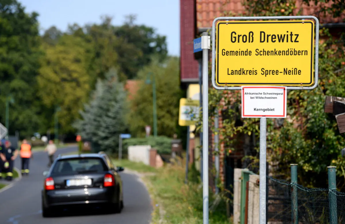 The town sign of Gross Drewitz with a note reading "African swine fever in wild pigs, key area" in Gross Drewitz, Spree-Neisse, Germany, on Sept. 12, 2020. (Annegret Hilse/Reuters)