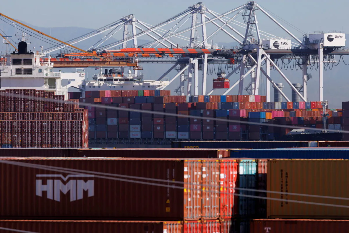 Stacked containers are shown as ships unload their cargo at the Port of Los Angeles in Los Angeles on Nov. 22, 2021. (Mike Blake/Reuters)