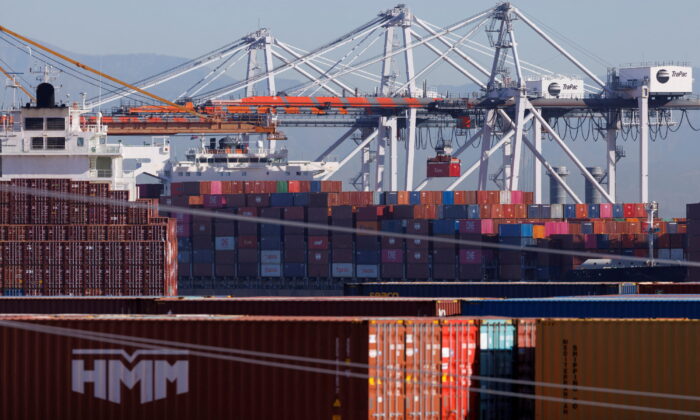 Stacked containers are shown as ships unload their cargo at the Port of Los Angeles in Los Angeles, Calif., on Nov. 22, 2021. (Mike Blake/Reuters)