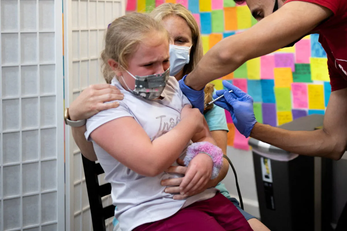 Mackenzie Bubel, 8, receives a Pfizer-BioNTech COVID-19 vaccine booster shot at Skippack Pharmacy in Schwenksville, Pa., on June 2, 2022. (Hannah Beier/Reuters)