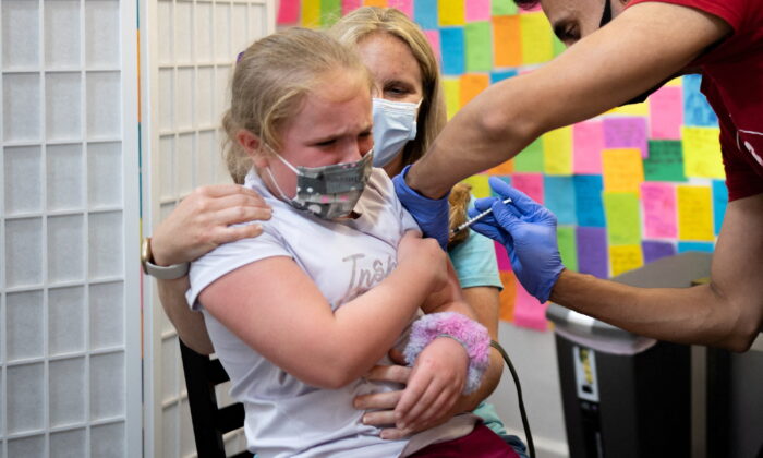Mackenzie Bubel, 8, receives a Pfizer-BioNTech COVID-19 vaccine booster shot at Skippack Pharmacy in Schwenksville, Pa., on June 2, 2022. (Hannah Beier/Reuters)