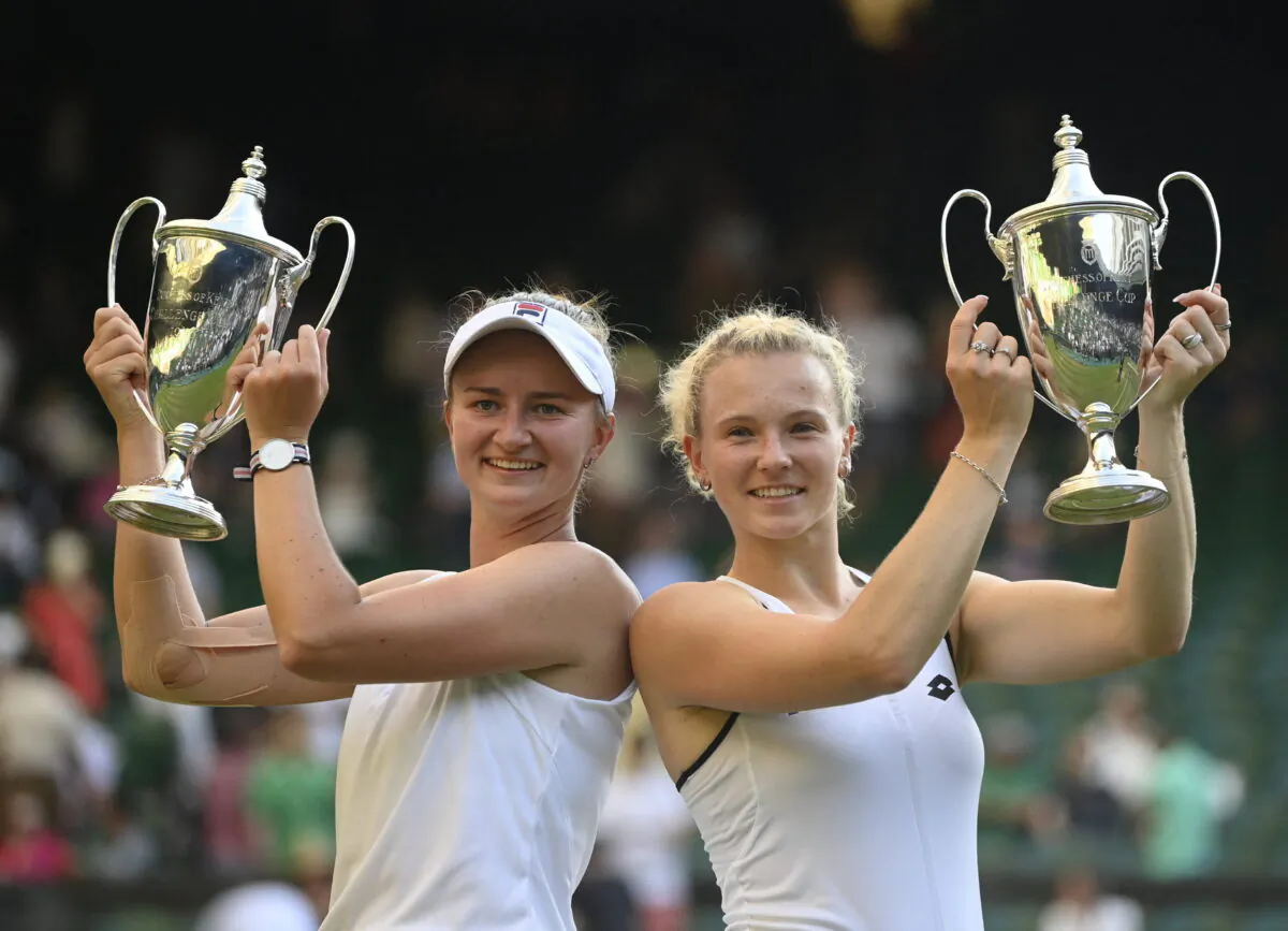 Czech Republic's Katerina Siniakova and Czech Republic's Barbora Krejcikova pose with the trophies after winning the women's doubles final against China's Zhang Shuai and Belgium's Elise Mertens during the Wimbledon Championships at the All England Lawn Tennis and Croquet Club in London on July 10, 2022. (Toby Melville/Reuters)
