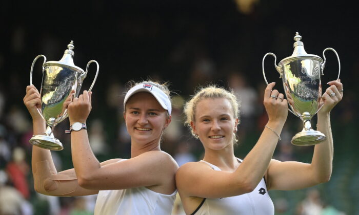 Czech Republic's Katerina Siniakova and Czech Republic's Barbora Krejcikova pose with the trophies after winning the women's doubles final against China's Zhang Shuai and Belgium's Elise Mertens during the Wimbledon Championships at the All England Lawn Tennis and Croquet Club in London on July 10, 2022. (Toby Melville/Reuters)