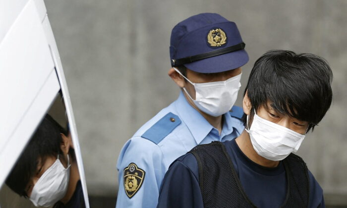 Tetsuya Yamagami, who is suspected of killing former Prime Minister Shinzo Abe, is taken to a prosecutor at the Nara Prefectural Police Station in Nara Prefecture, in this photo taken by Kyodo on July 10, 2022. Credit Kyodo via REUTERS 