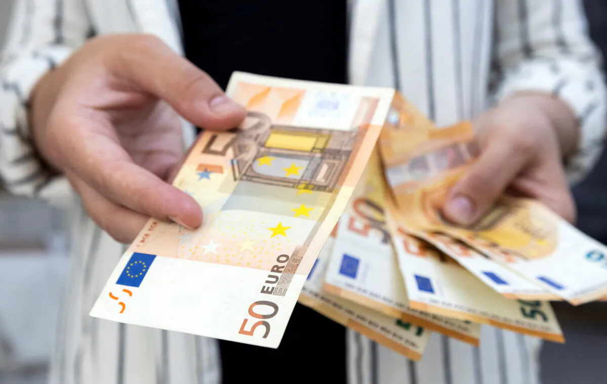 A woman holds Euro banknotes in this illustration taken on May 30, 2022. (Dado Ruvic/Reuters)