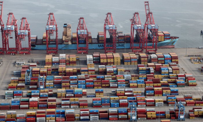 Shipping containers are unloaded from a ship at a container terminal at the Port of Long Beach–Port of Los Angeles complex on April 7, 2021. (Lucy Nicholson/Reuters)