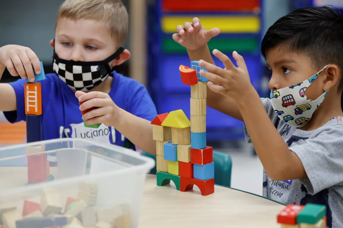 Children wear masks as they wait for President Joe Biden to visit their pre-Kindergarten class at East End Elementary School in North Plainfield, N.J., on Oct. 25, 2021. (Jonathan Ernst/Reuters)