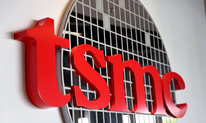 FILE PHOTO: The logo of Taiwan Semiconductor Manufacturing Co (TSMC) is pictured at its headquarters, in Hsinchu, Taiwan, Jan. 19, 2021. REUTERS/Ann Wang