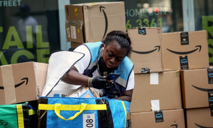 An Amazon delivery worker checks packages in New York City on July 11, 2022. (Brendan McDermid/Reuters)