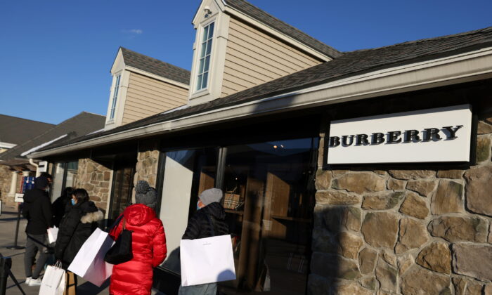 People stand outside Burberry at the Woodbury Common Premium Outlets in Central Valley, N.Y., on Feb. 15, 2022. (Andrew Kelly/Reuters)