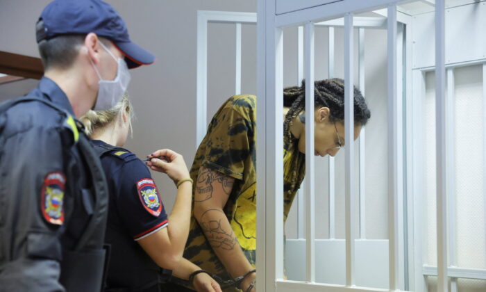Basketball player Brittney Griner, who was detained at Moscow's Sheremetyevo airport and later charged with illegal possession of cannabis, is escorted before a court hearing in Khimki outside Moscow on July, 15, 2022. (Evgenia Novozhenina/Reuters)