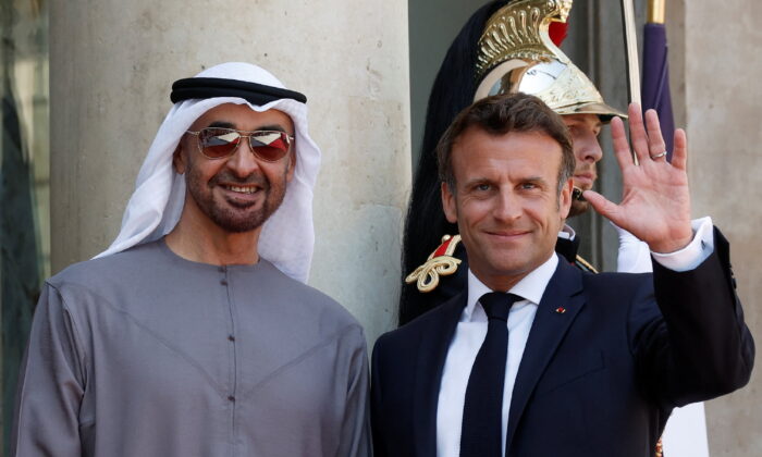 French President Emmanuel Macron welcomes UAE President Sheikh Mohammed bin Zayed al-Nahyan (L) as he arrives for a meeting at the Elysee Palace in Paris on July 18, 2022. (Benoit Tessier/Reuters)