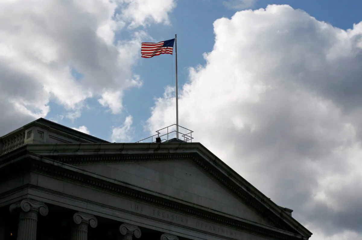 The U.S. flag flies atop the Treasury Department in Washington on Nov. 18, 2008. (Jim Bourg/Reuters)