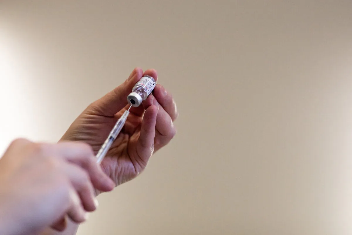 A nurse fills syringes with the COVID-19 vaccine in Michigan, on April 8, 2022. (Reuters/Emily Elconin)