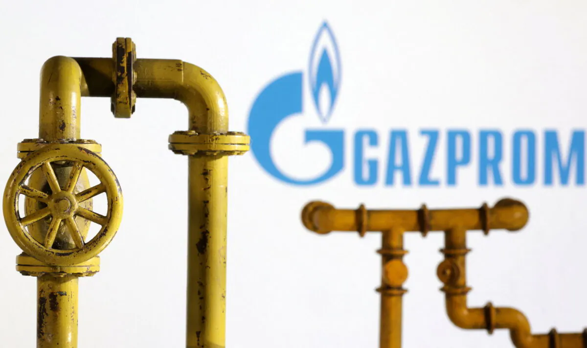 Model of natural gas pipeline and Gazprom logo, on July 18, 2022. (Dado Ruvic/Illustration/Reuters)