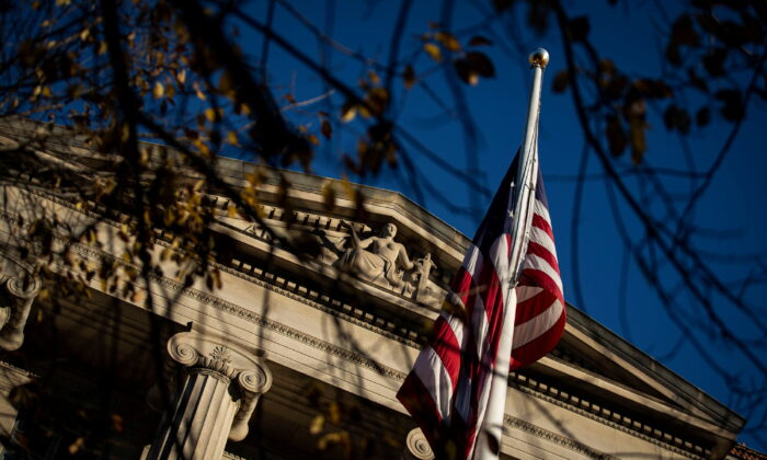 An American flag waves outside the U.S. Department of Justice Building in Washington, on Dec. 15, 2020. (Al Drago/Reuters)