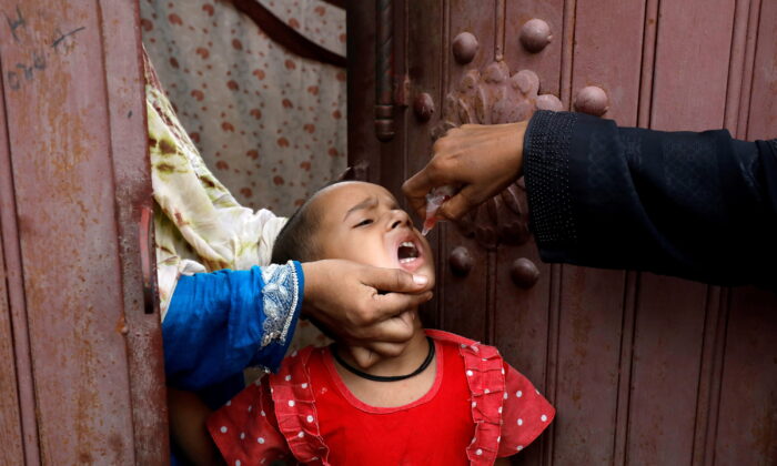 A girl receives polio vaccine drops during an anti-polio campaign in a low-income neighborhood as the spread of COVID-19 continues in Karachi, Pakistan, on July 20, 2020. (Akhtar Soomro/Reuters)